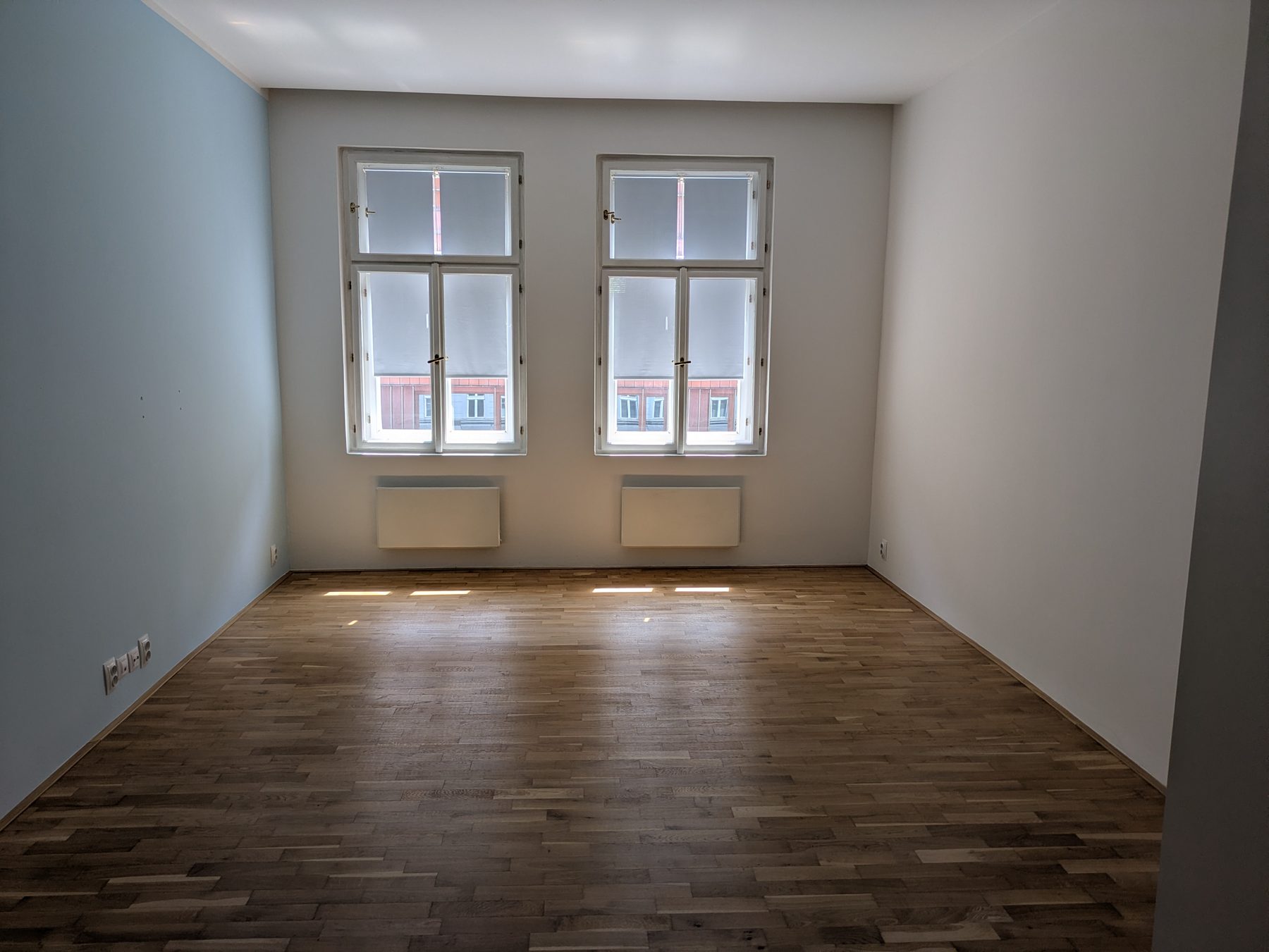 Obývací pokoj s okny do ulice